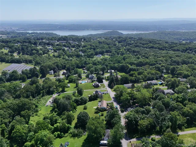 an aerial view of a city with lots of residential buildings and green space