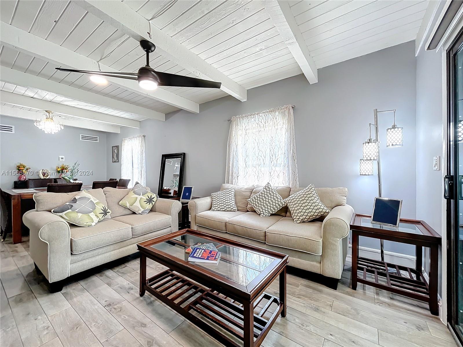 10324 Sleepy Brook Way Boca Raton, FL 33428 - Photo 11 of 29 a living room with furniture a ceiling fan and a wooden floor