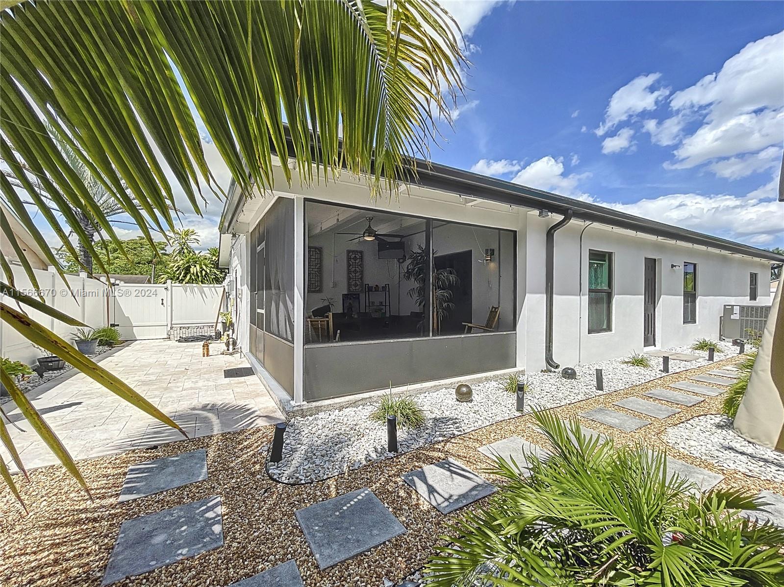 10324 Sleepy Brook Way Boca Raton, FL 33428 - Photo 20 of 29 a view of a house with backyard porch and patio