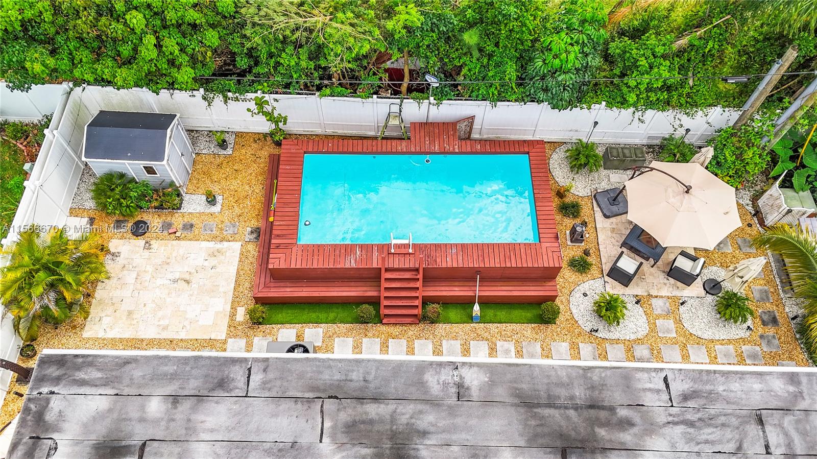10324 Sleepy Brook Way Boca Raton, FL 33428 - Photo 25 of 29 an aerial view of a house with a garden and a patio