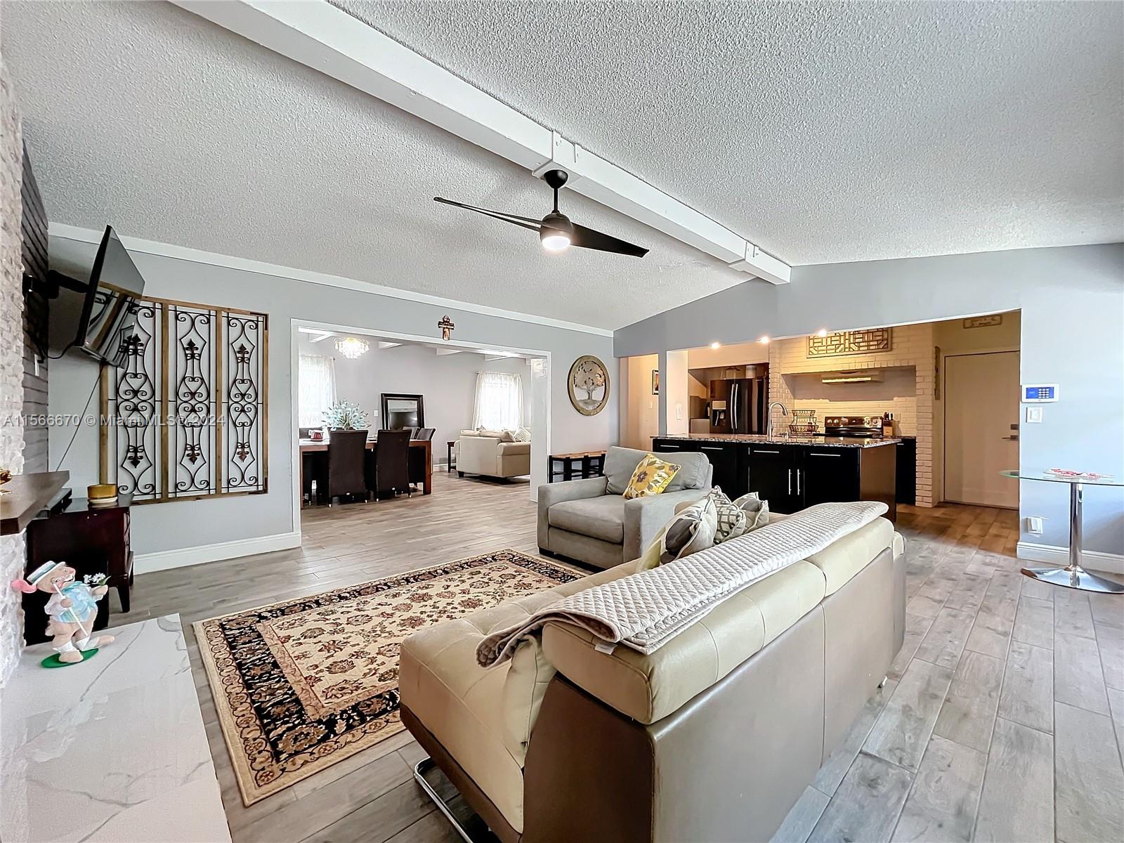 10324 Sleepy Brook Way Boca Raton, FL 33428 - Photo 4 of 29 a living room with furniture and a rug