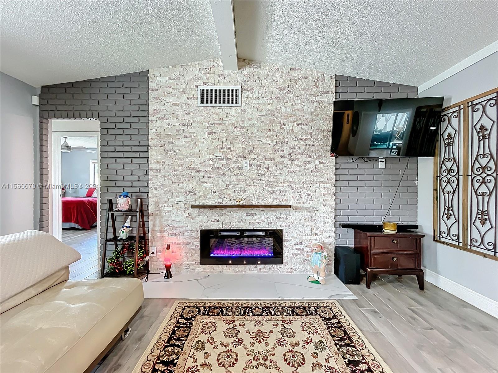10324 Sleepy Brook Way Boca Raton, FL 33428 - Photo 5 of 29 a living room with furniture and a fireplace