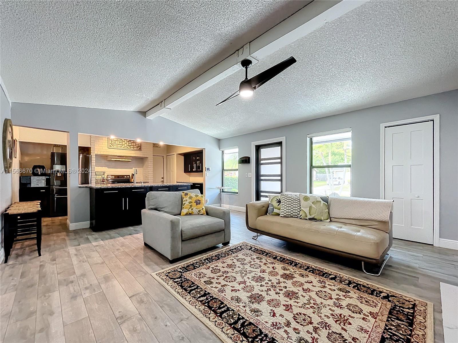 10324 Sleepy Brook Way Boca Raton, FL 33428 - Photo 6 of 29 a living room with furniture and wooden floor