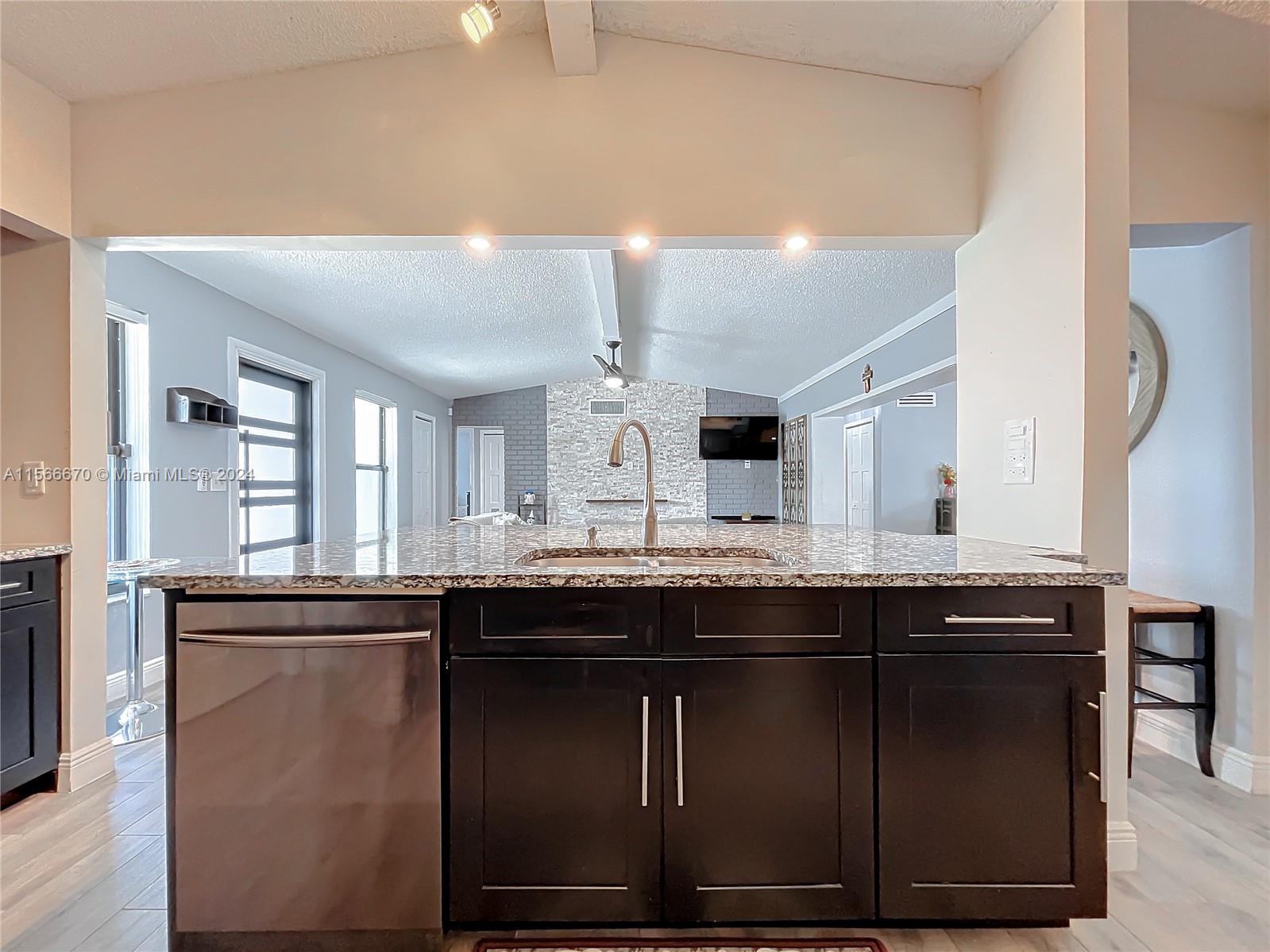 10324 Sleepy Brook Way Boca Raton, FL 33428 - Photo 8 of 29 a kitchen with a sink and cabinets