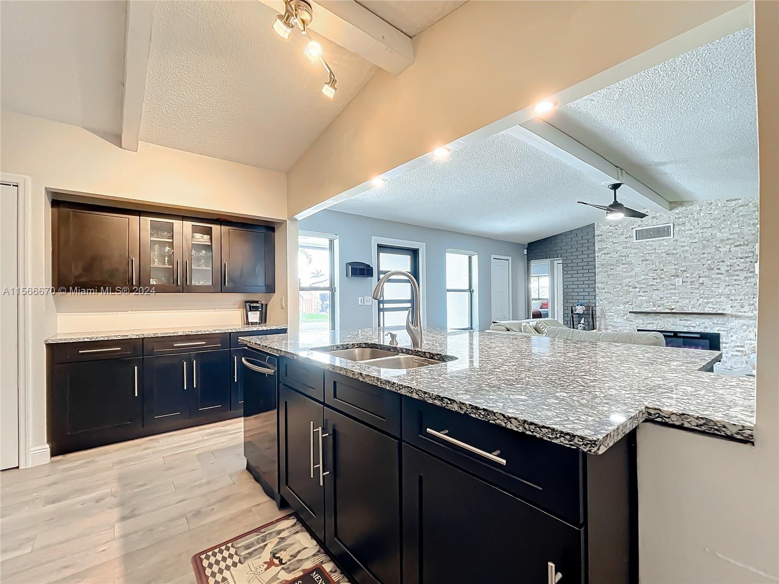 10324 Sleepy Brook Way Boca Raton, FL 33428 - Photo 9 of 29 a kitchen with a stove sink and cabinets