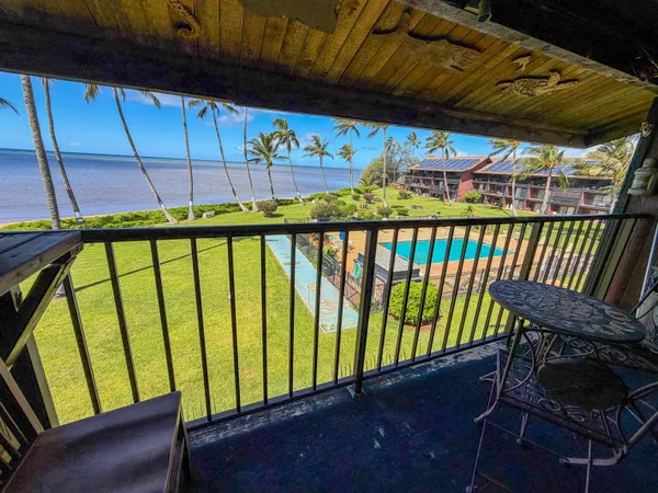 a view of a chair and table in the balcony