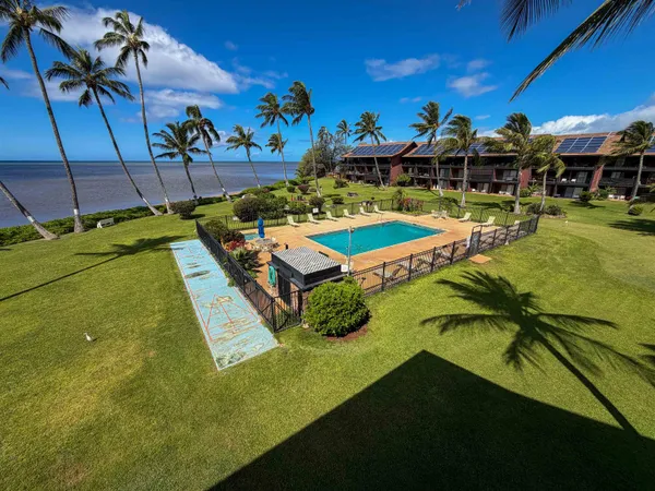 a view of a swimming pool with outdoor seating