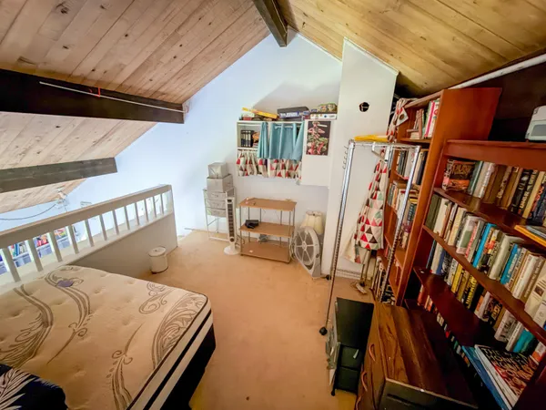 a bed room with a bed and a book shelf