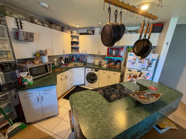 a kitchen with a stove a microwave a sink and a dining table