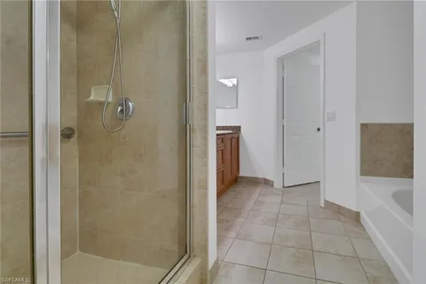 an empty room with a chandelier fan