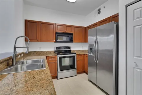 a kitchen with stainless steel appliances granite countertop a stove and a microwave