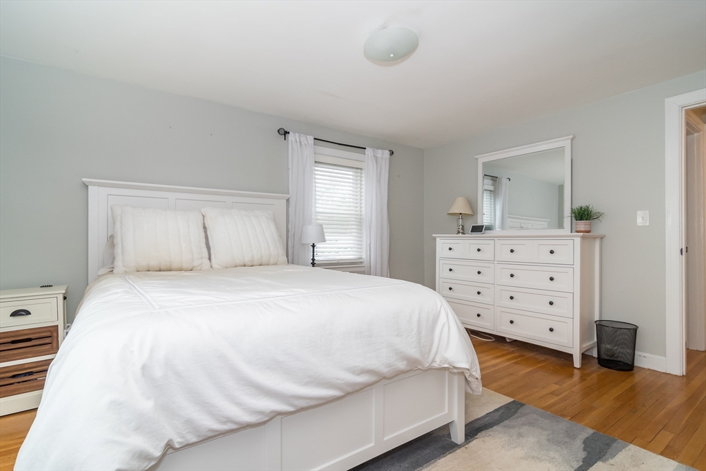 53 Bacon Street Natick, MA 01760 - Photo 16 of 30 a bedroom with a bed and cabinet