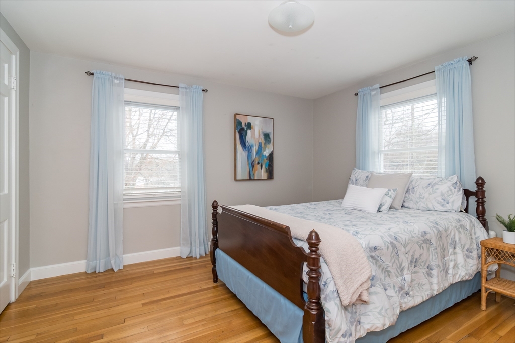 53 Bacon Street Natick, MA 01760 - Photo 17 of 30 a bedroom with a bed and wooden floor