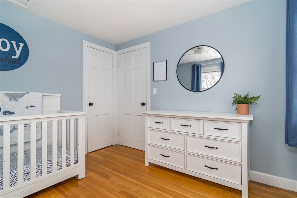 53 Bacon Street Natick, MA 01760 - Photo 19 of 30 a view of a bedroom with baby bed and closet
