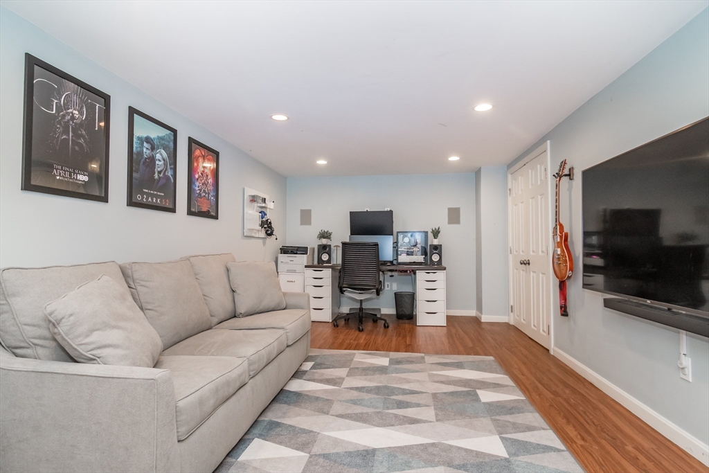 53 Bacon Street Natick, MA 01760 - Photo 21 of 30 a living room with furniture and a flat screen tv