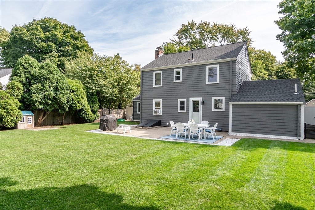 53 Bacon Street Natick, MA 01760 - Photo 25 of 30 a front view of house with outdoor seating yard and green space