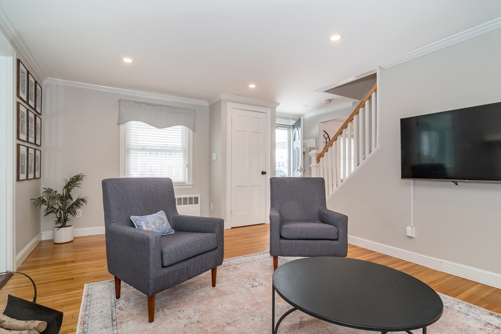 53 Bacon Street Natick, MA 01760 - Photo 5 of 30 a living room with furniture and a flat screen tv