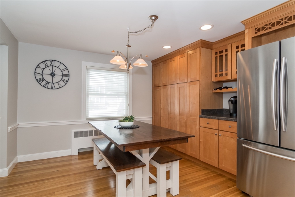53 Bacon Street Natick, MA 01760 - Photo 9 of 30 a kitchen with stainless steel appliances a refrigerator a table and chairs