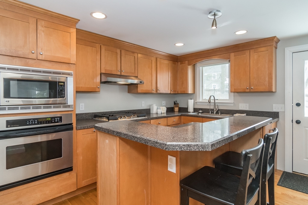 53 Bacon Street Natick, MA 01760 - Photo 10 of 30 a kitchen with a sink stove and microwave
