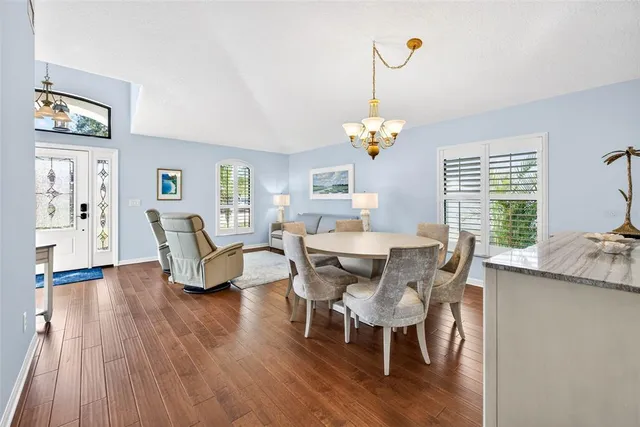a bedroom with a bed and a dresser with wooden floor