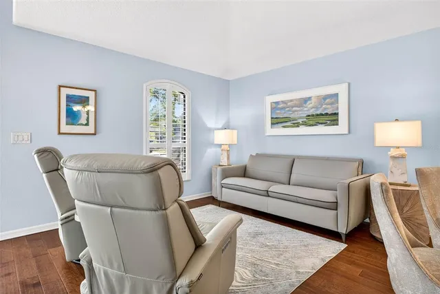 a view of a dining room with furniture wooden floor and a chandelier