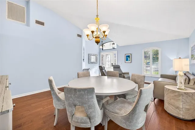 a view of a room that has a bed and a table in it