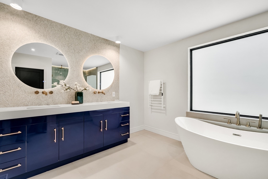 70 Birch Hill Road Belmont, MA 02478 - Photo 37 of 41 a bathroom with a double vanity sink and mirror with bathtub