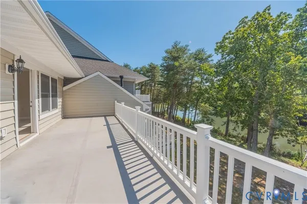 a view of a balcony with wooden floor and fence