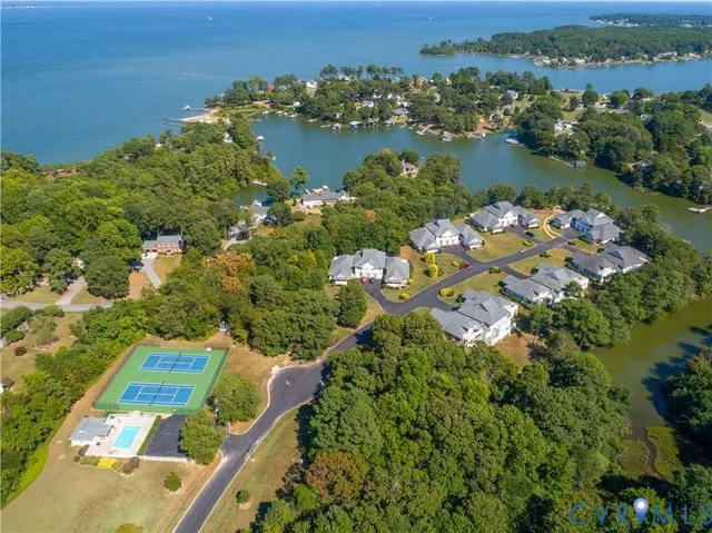 an aerial view of lake residential house with outdoor space and trees all around