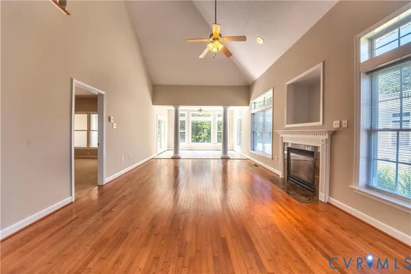 wooden floor in an empty room with a window