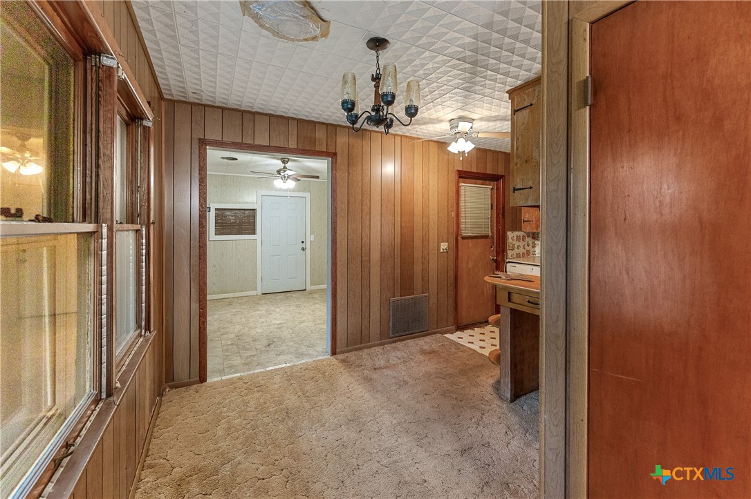 401 Kerr Street Edna, TX 77957 - Photo 8 of 23 a view of a hallway with a chandelier