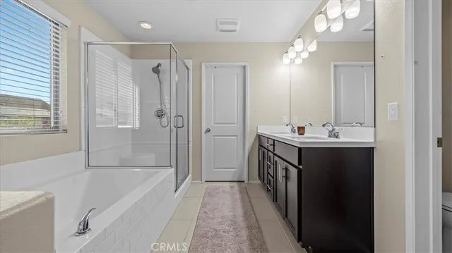 a bathroom with a tub sink shower and mirror