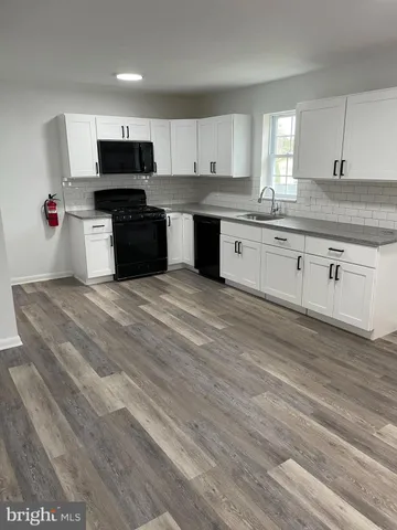 a kitchen with stainless steel appliances granite countertop a sink and cabinets