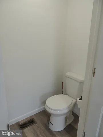 a white toilet sitting next to a white sink