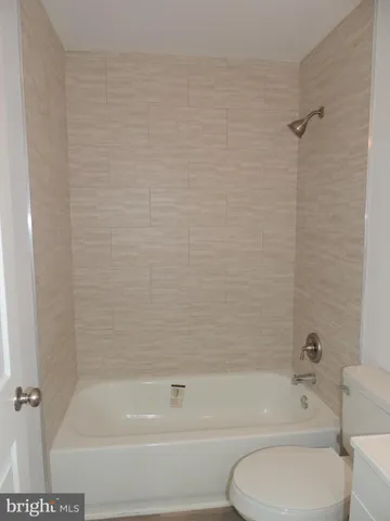 a bathroom with a bathtub and a toilet