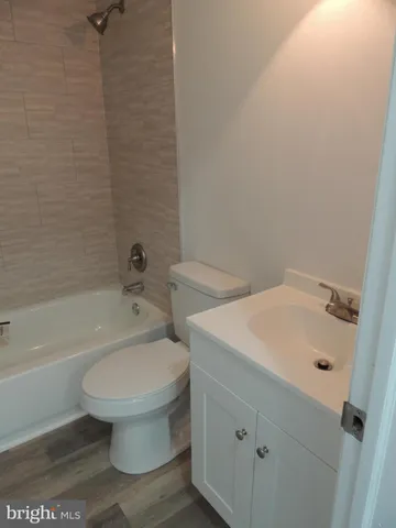a white toilet sitting next to a bath tub
