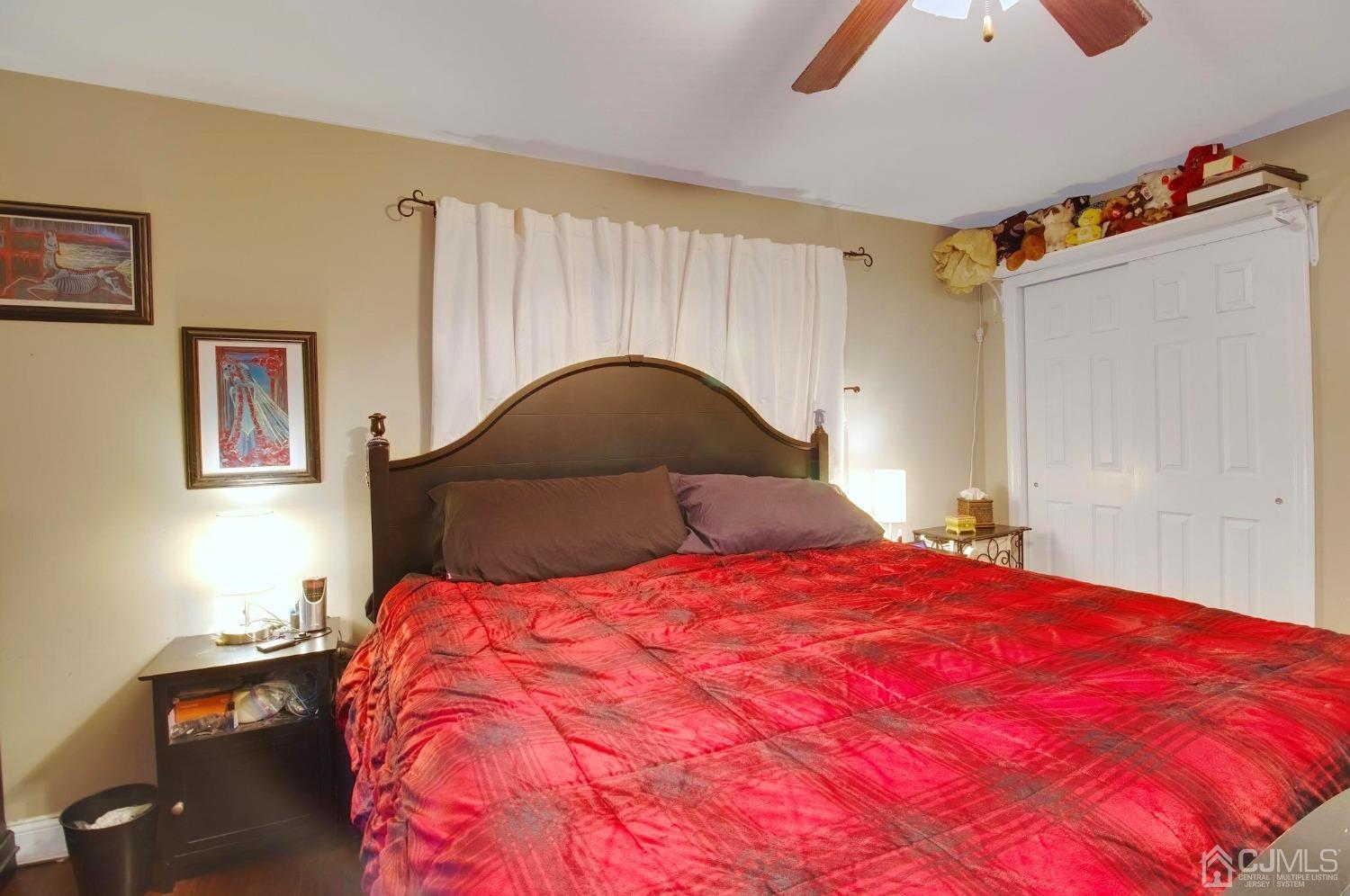 225 New Dover Road Colonia, NJ 07067 - Photo 18 of 33 a bedroom with a bed and a potted plant on dresser