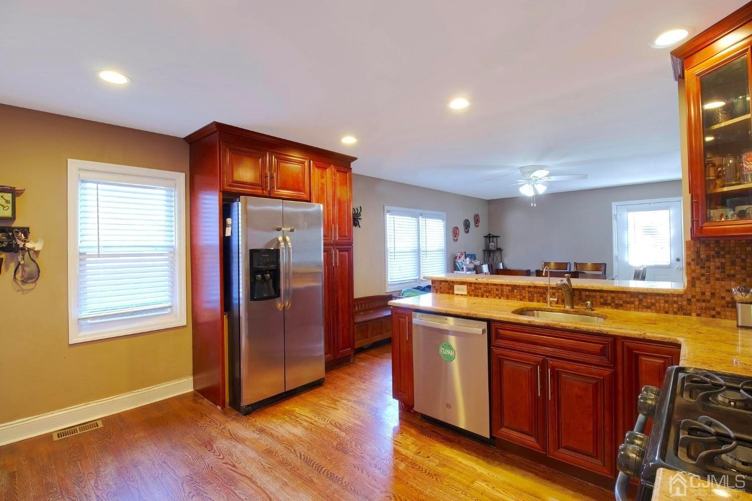 225 New Dover Road Colonia, NJ 07067 - Photo 8 of 33 a kitchen with stainless steel appliances granite countertop a sink and a refrigerator