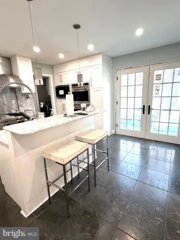 a large white kitchen with a large window
