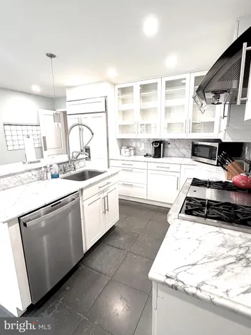 a kitchen with a stove a sink and a refrigerator