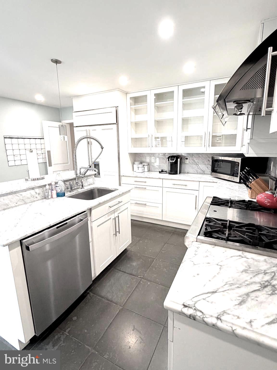 5103 Yuma Street Northwest Washington, DC 20016 - Photo 7 of 21 a kitchen with a stove a sink and a refrigerator