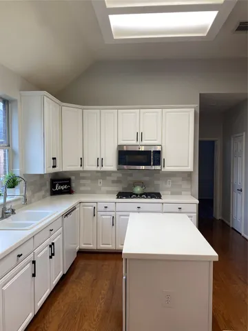 a spacious bathroom with a double vanity sink mirror and toilet
