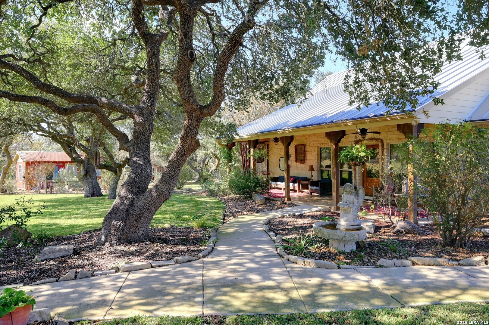a view of a patio with table and chairs under an umbrella