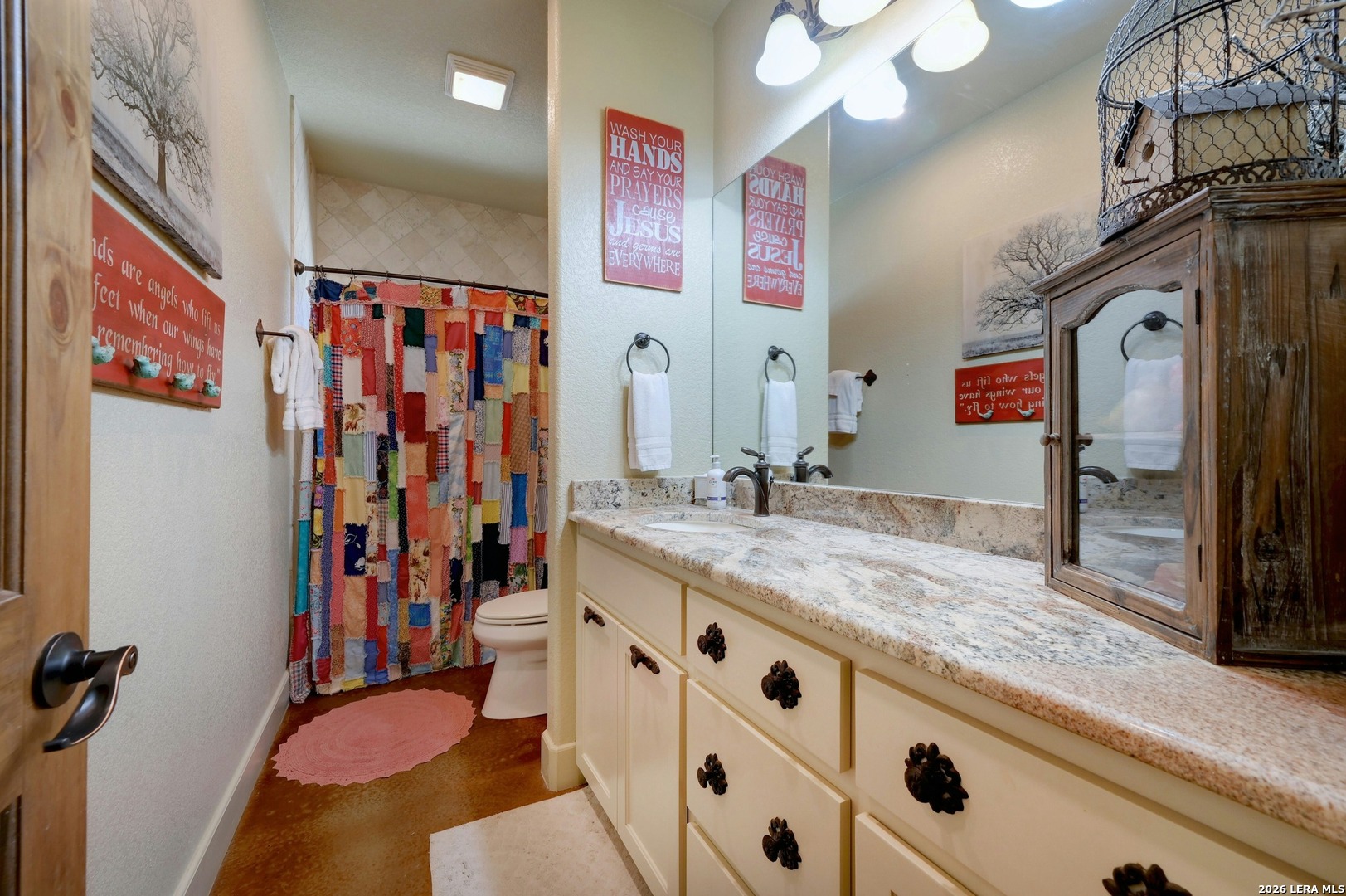 316 Go Away Road Blanco, TX 78606 - Photo 28 of 40 a bathroom with a granite countertop sink and a mirror