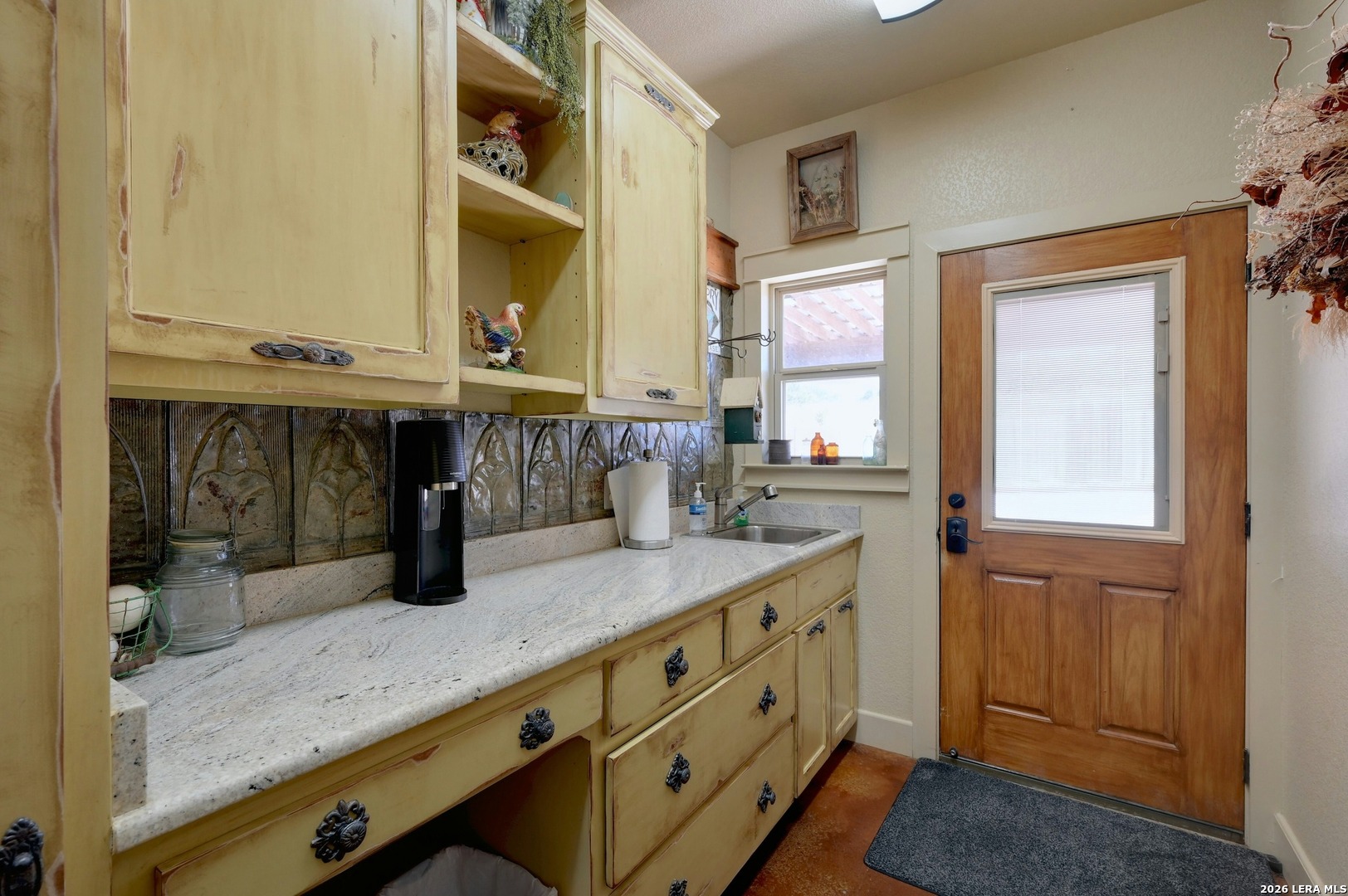 316 Go Away Road Blanco, TX 78606 - Photo 30 of 40 a bathroom with a granite countertop sink and a mirror