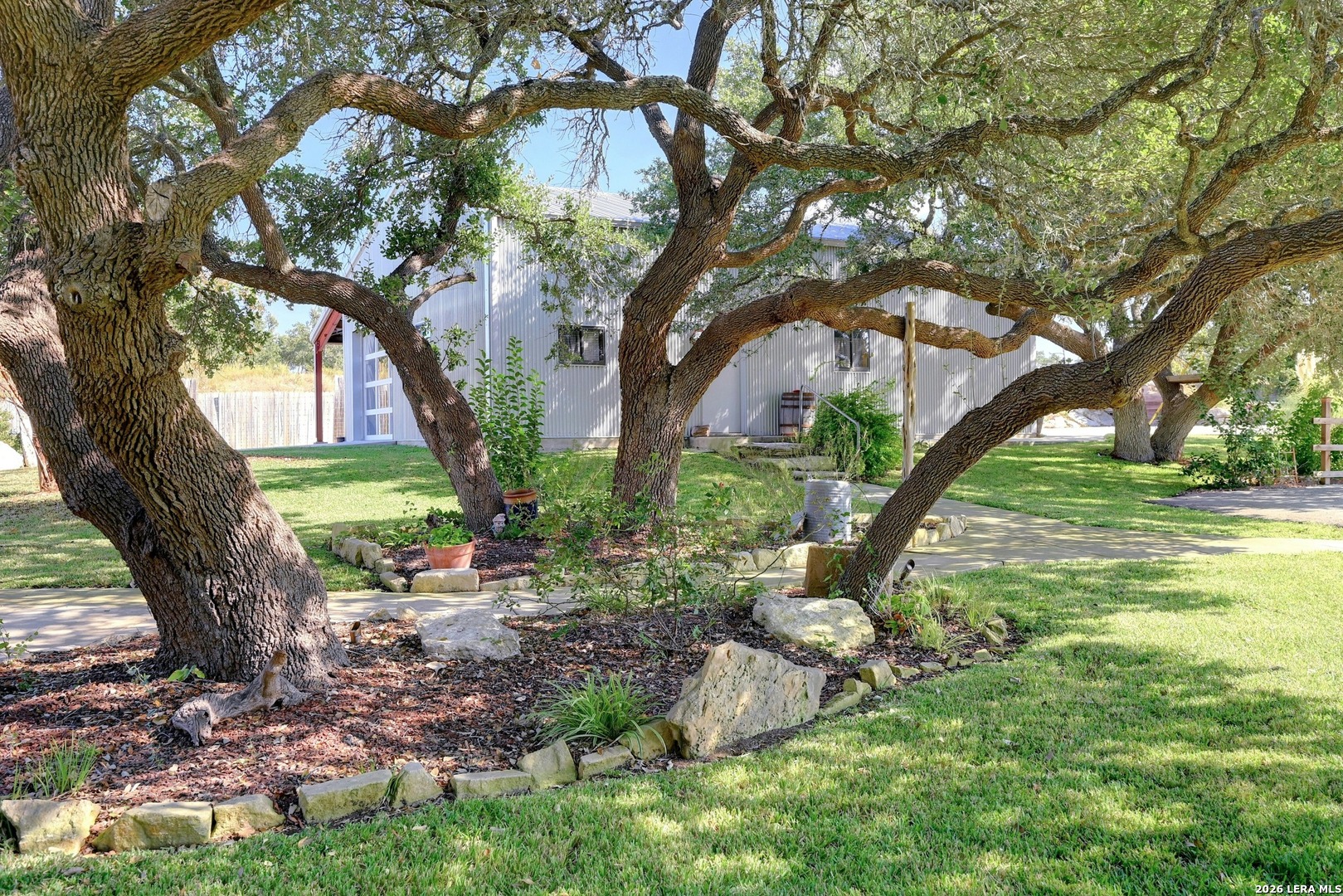 316 Go Away Road Blanco, TX 78606 - Photo 3 of 40 a view of a garden with a tree