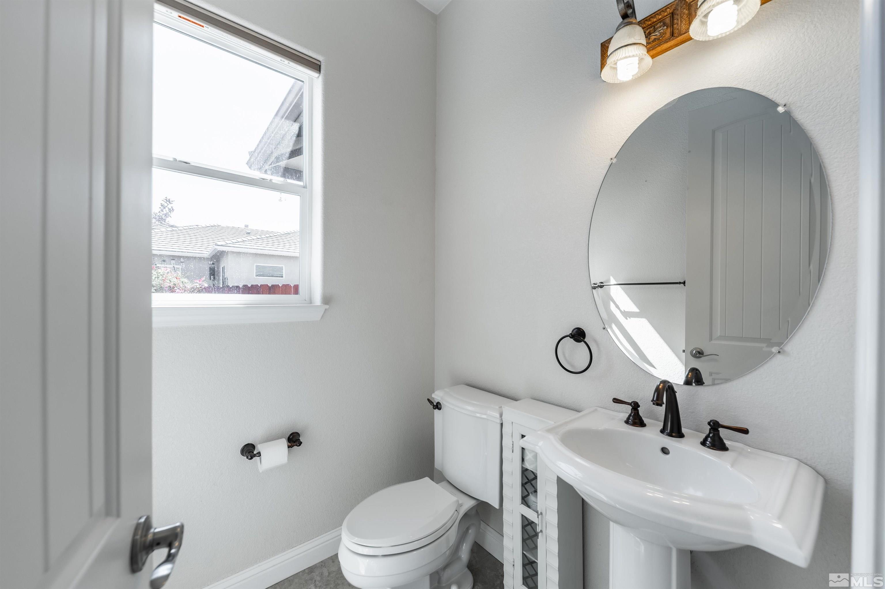 985 Bella Monte Drive Minden, NV 89423 - Photo 29 of 37 a bathroom with a toilet sink and mirror