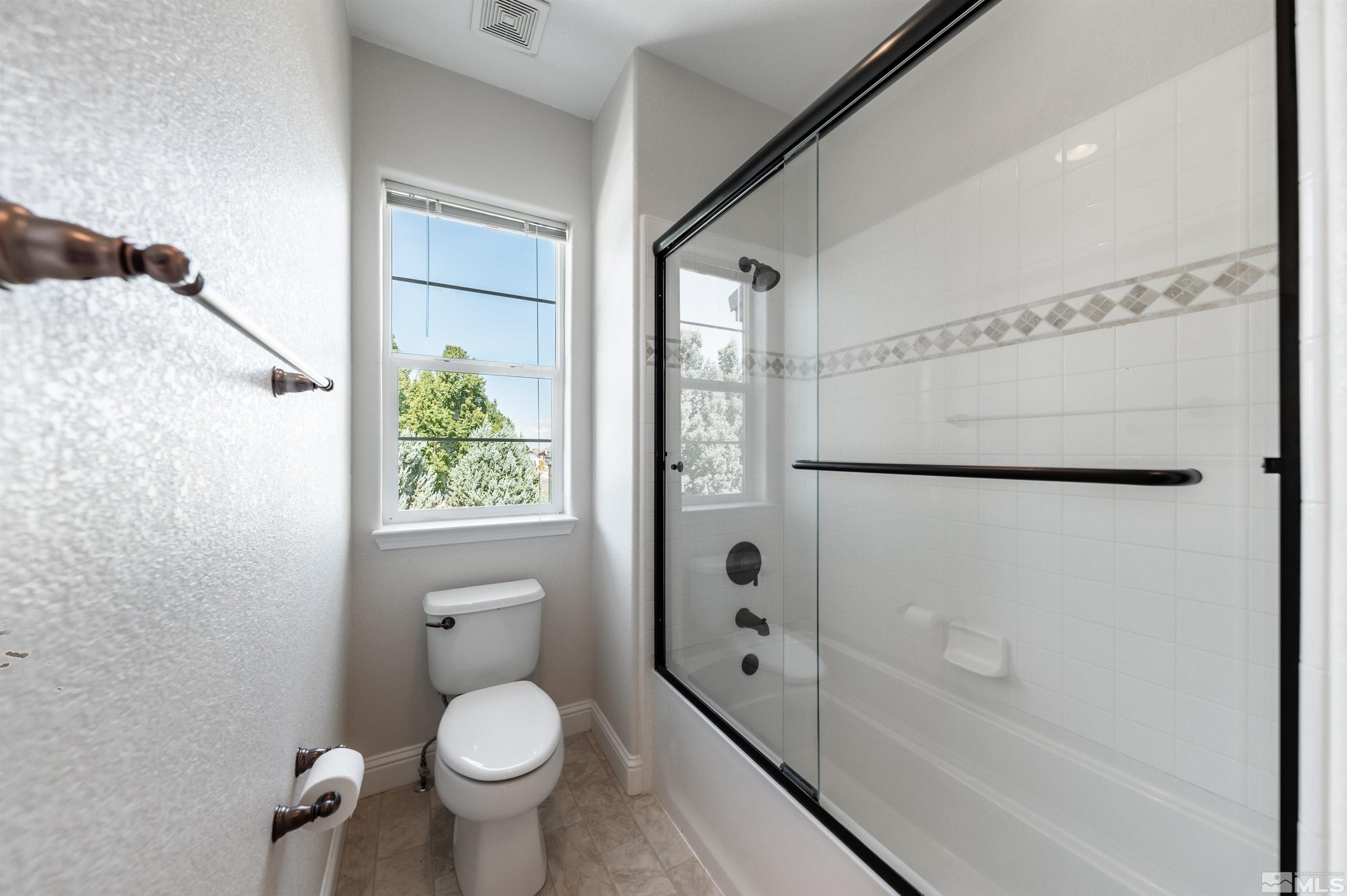 985 Bella Monte Drive Minden, NV 89423 - Photo 33 of 37 a bathroom with a granite countertop toilet a sink and shower