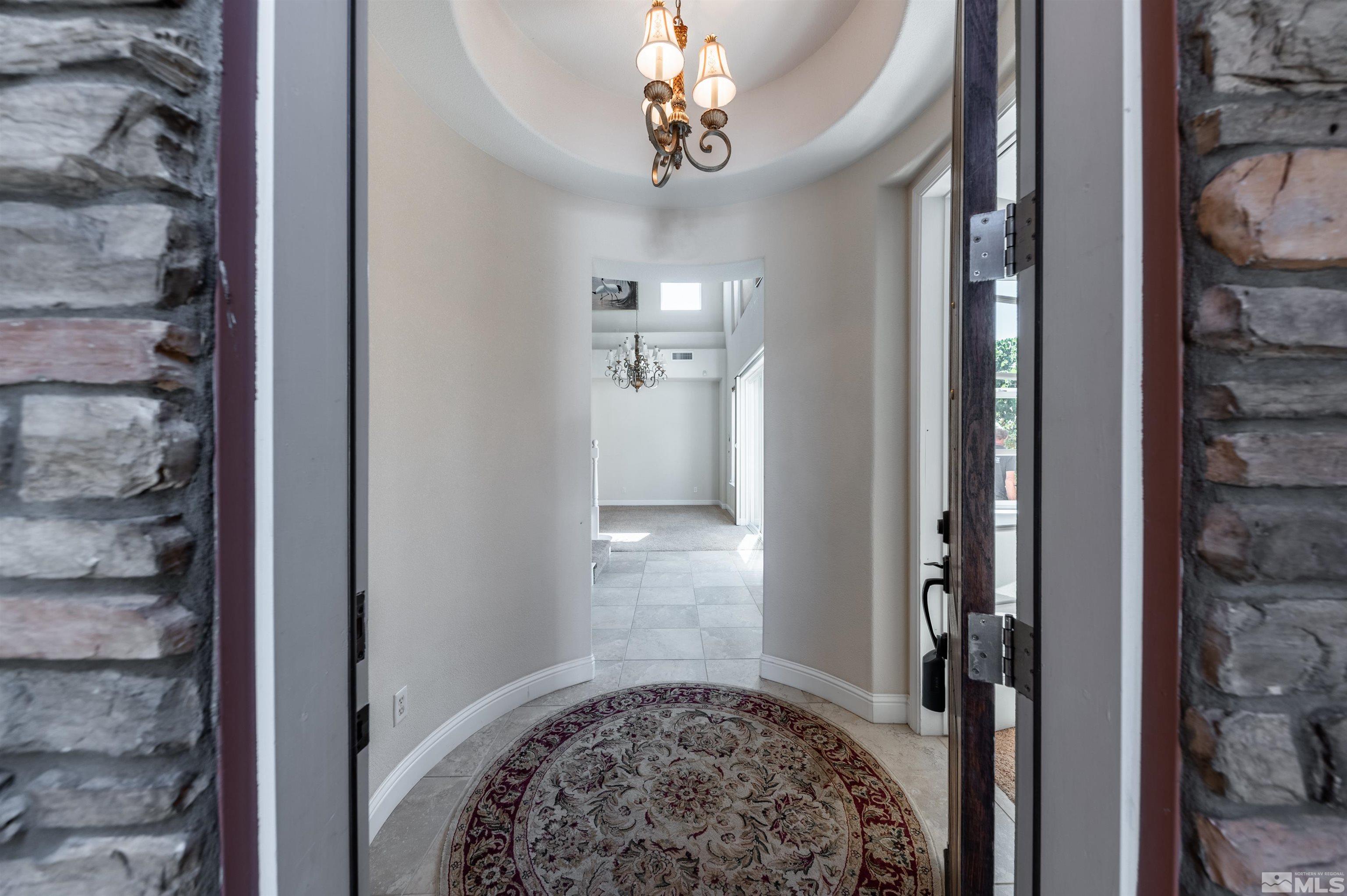 985 Bella Monte Drive Minden, NV 89423 - Photo 6 of 37 a view of a hallway with windows and chandelier