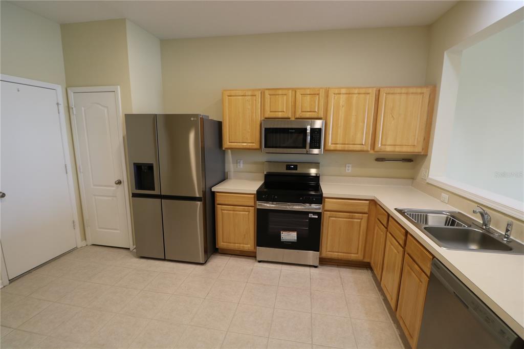 4866 Pond Ridge Drive Riverview, FL 33578 - Photo 12 of 38 a kitchen with stainless steel appliances a refrigerator stove and sink